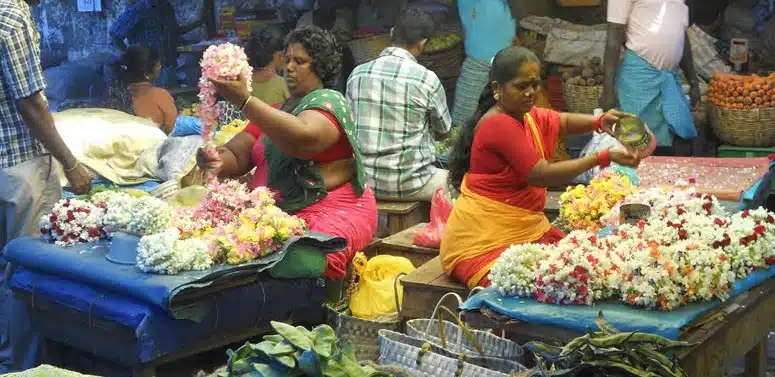 women-making-flower-garlands-india