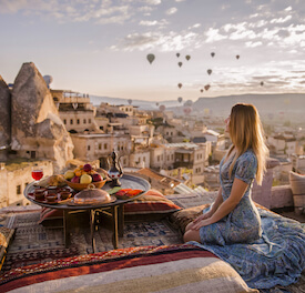 girl watching hot air balloons