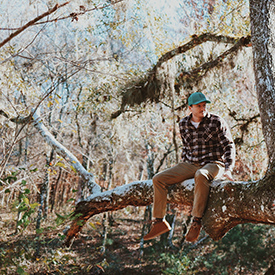 Guy sitting on a branch