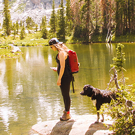 Lady with dog by a lake