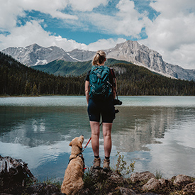 lady with dog by the lake