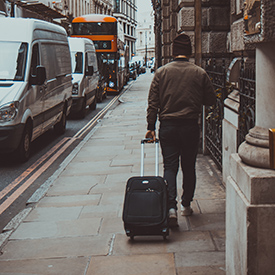 Man on street with carry-on