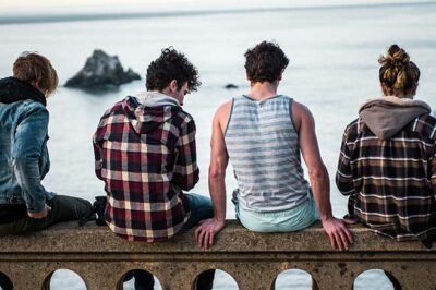teen sitting on railing