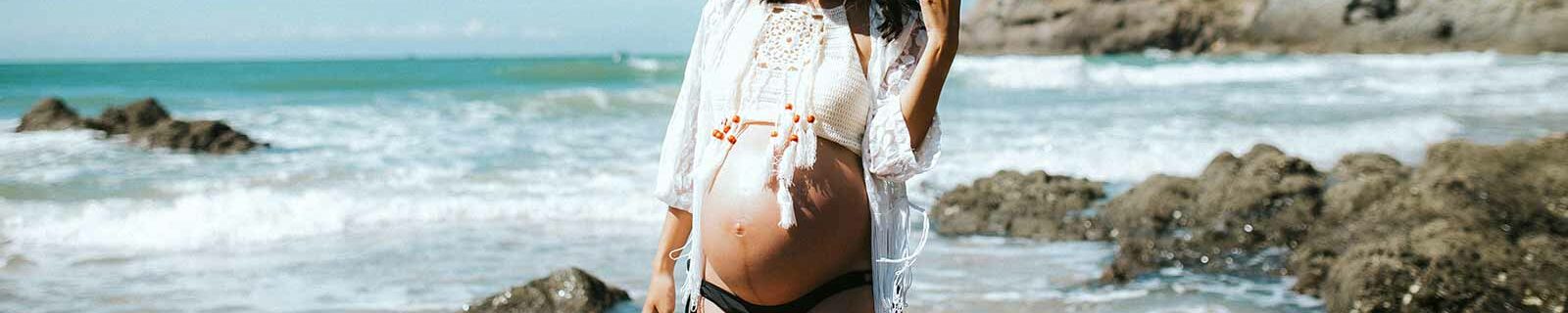 Pregnant woman walking the beach