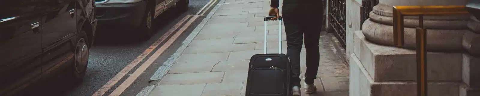 Guying pulling his luggage