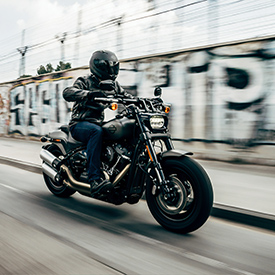 guy wearing leather jacket on a motorcycle