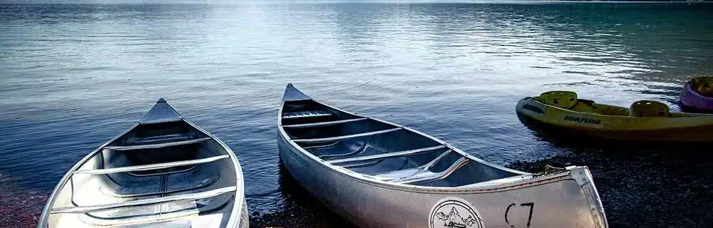 Canoes resting lakeside