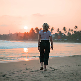 Woman walking on beach in Sri Lanka