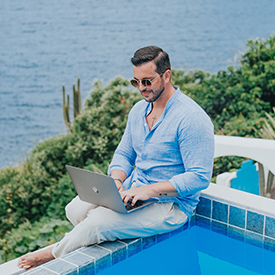 guy-working-by-the-pool-and-ocean