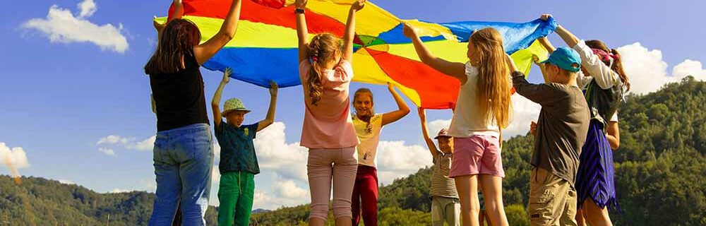 Summer Camper's playing with parachute