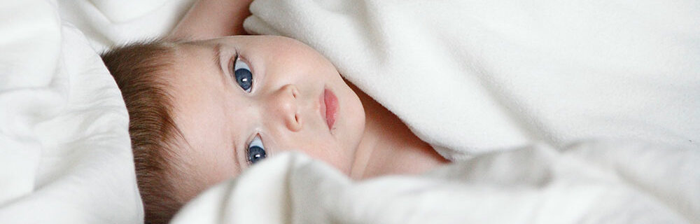 Baby playing in bed