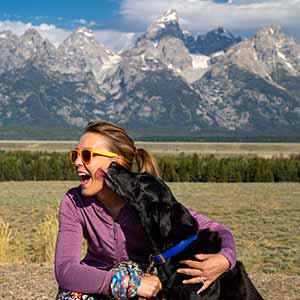 Getting kisses from dog in wyoming mountains