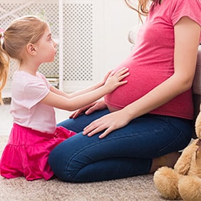 pregnant mother with daughter