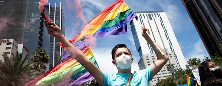 Protestor holding rainbow flag